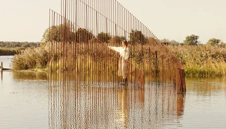 hundreds of vertical untreated steel rebars shape maetherea's kinetic installation in the UK