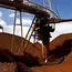Iron ore eases on uncertain demand but heads for weekly gain